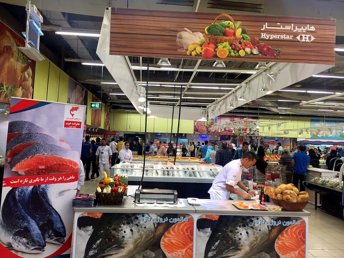 An in-store salmon demonstration at a hypermarket seafood counter